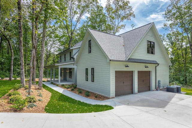 460 Spring Dr, Signal Mountain, TN 37377 - view of side of home with central AC unit, roof with shingles, a porch, and a garage