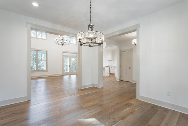460 Spring Dr, Signal Mountain, TN 37377 - unfurnished dining area with baseboards, a notable chandelier, and light wood-style floors