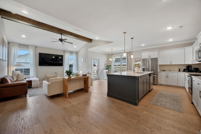 5812 Acadia Dr, Chattanooga, TN 37415 - kitchen featuring appliances with stainless steel finishes, open floor plan, a sink, white cabinets, and recessed lighting