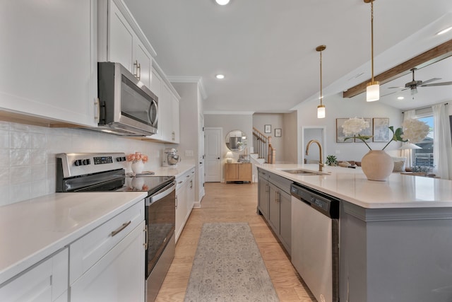 5812 Acadia Dr, Chattanooga, TN 37415 - kitchen with appliances with stainless steel finishes, a sink, backsplash, white cabinetry, and light countertops
