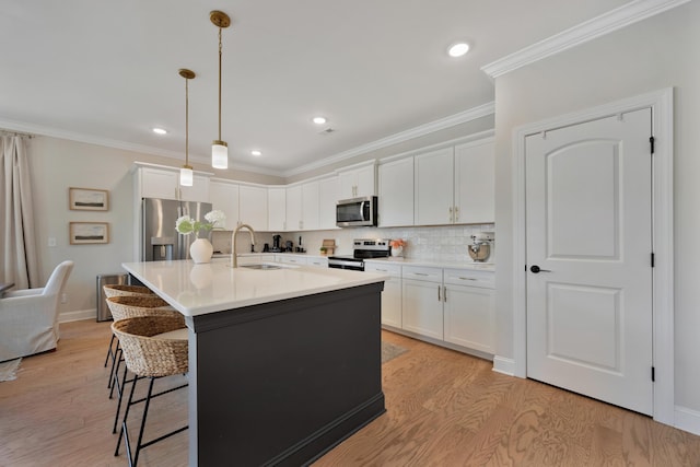 5812 Acadia Dr, Chattanooga, TN 37415 - kitchen featuring stainless steel appliances, light wood-style flooring, a breakfast bar area, crown molding, and white cabinetry