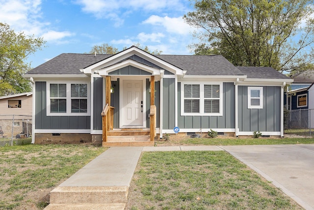 bungalow-style house featuring board and batten siding, crawl space, and a front lawn