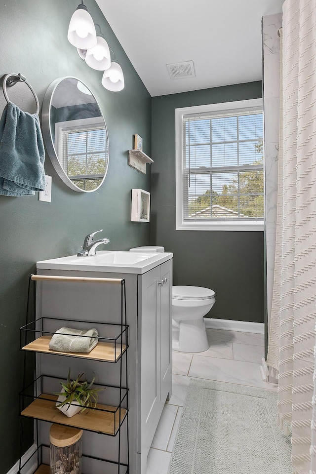 bathroom with vanity, curtained shower, marble finish floor, toilet, and visible vents