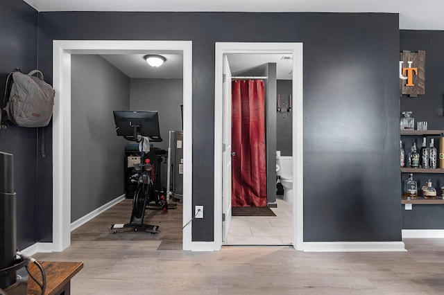 interior space with baseboards and wood finished floors
