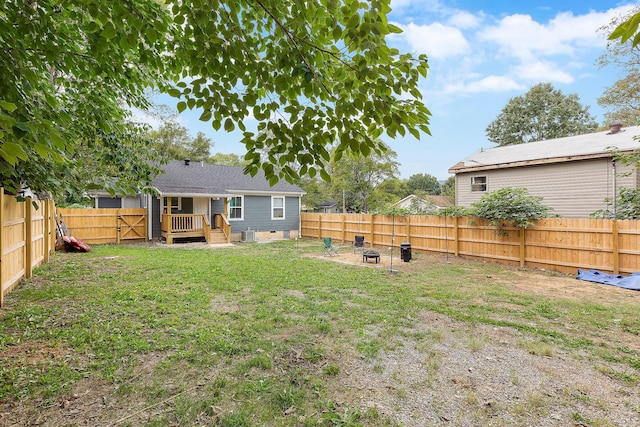 view of yard with a fenced backyard and an outdoor fire pit