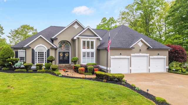 view of front facade featuring concrete driveway, roof with shingles, a front yard, an attached garage, and stucco siding