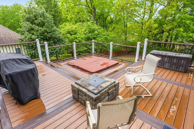 deck featuring a fire pit and a grill