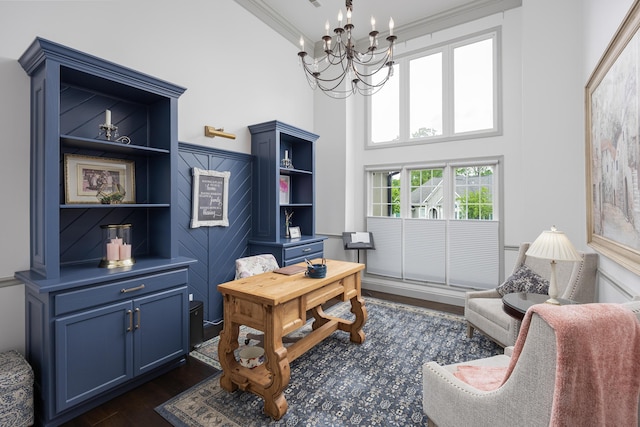 office featuring ornamental molding, a towering ceiling, a notable chandelier, and dark wood-style flooring