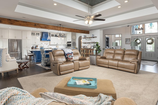 living area with ornamental molding, recessed lighting, dark wood-style floors, and a raised ceiling