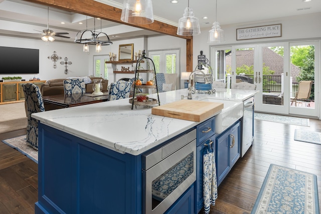 kitchen with a sink, blue cabinets, dishwasher, dark wood finished floors, and french doors