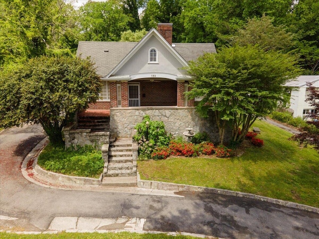 159 Gardner St, Chattanooga, TN 37411 - view of front of property with a front lawn, stone siding, a chimney, a porch, and stairway