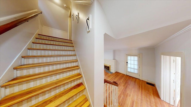159 Gardner St, Chattanooga, TN 37411 - staircase featuring visible vents, a fireplace, vaulted ceiling, wood finished floors, and baseboards