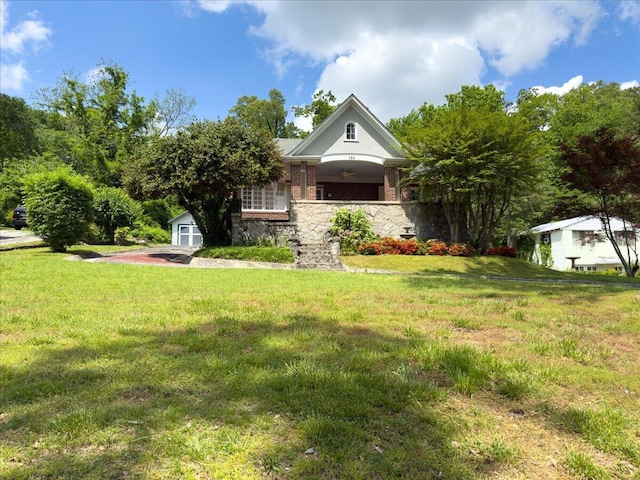159 Gardner St, Chattanooga, TN 37411 - view of front of property featuring a front lawn, a shed, an outbuilding, and stone siding