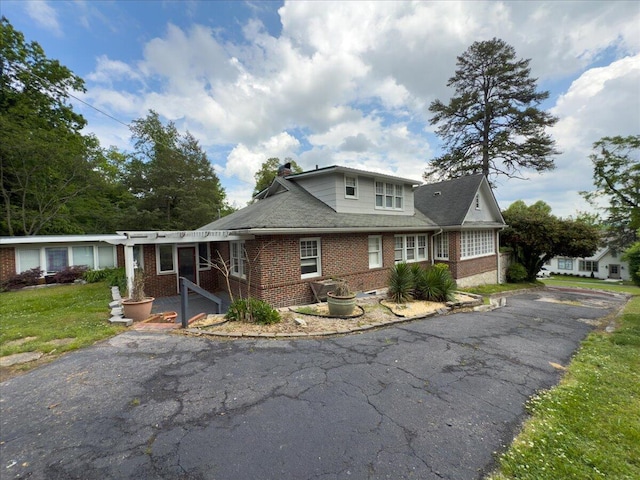 159 Gardner St, Chattanooga, TN 37411 - view of front of home with brick siding, a front lawn, aphalt driveway, and a chimney