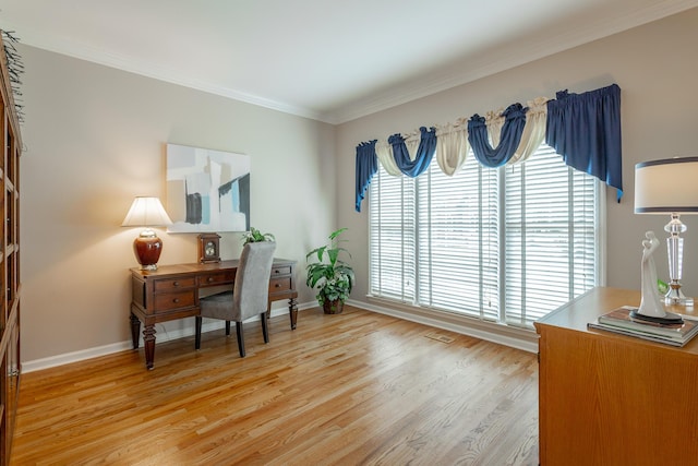 office featuring crown molding, baseboards, and light wood-style floors