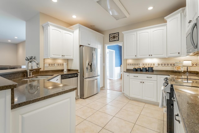 kitchen featuring a sink, white cabinets, and stainless steel appliances