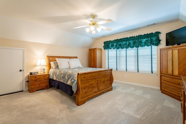 bedroom featuring baseboards, light carpet, and vaulted ceiling