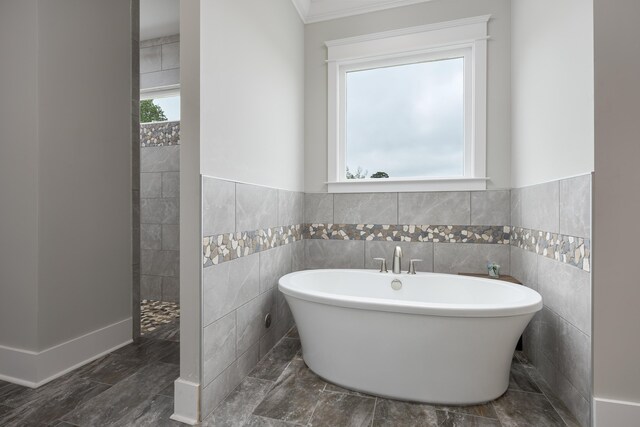 2419 Welch Rd, Soddy Daisy, TN 37379 - full bath featuring ornamental molding, a freestanding tub, tile walls, walk in shower, and a wainscoted wall