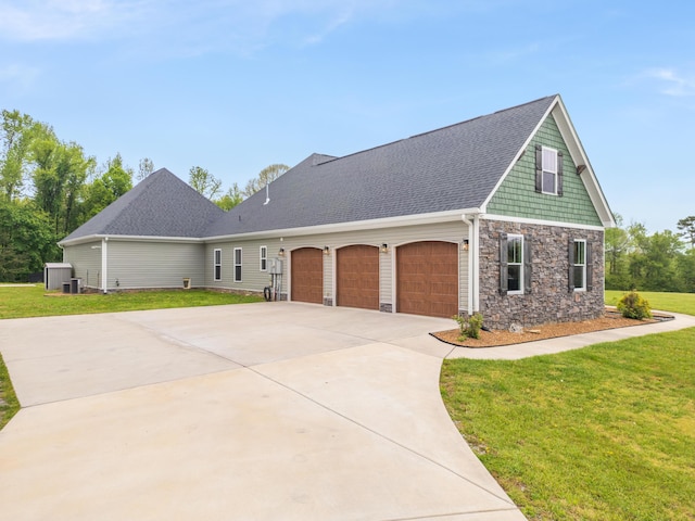 2419 Welch Rd, Soddy Daisy, TN 37379 - view of front of house with a shingled roof, an attached garage, a front lawn, stone siding, and driveway