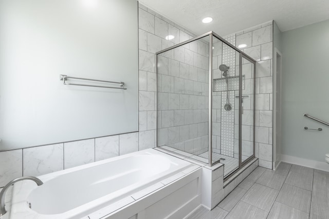 full bathroom featuring a stall shower, toilet, and a bath