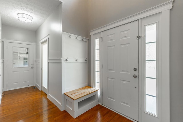 foyer featuring dark wood finished floors and a textured ceiling