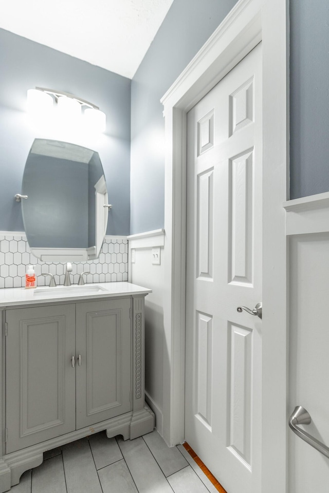 bathroom with tile patterned floors, vanity, and decorative backsplash