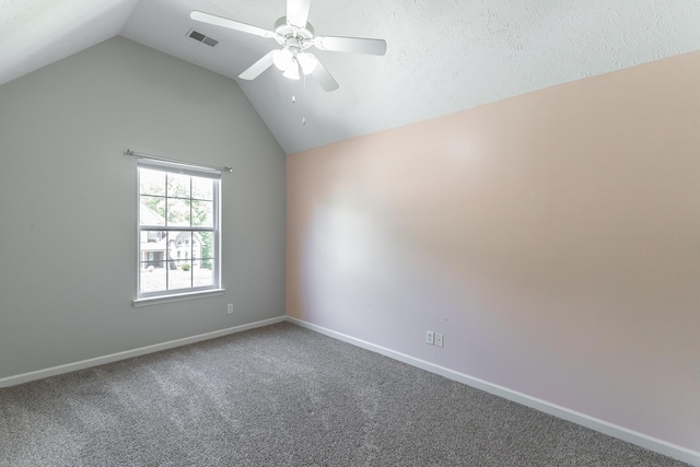 carpeted spare room featuring ceiling fan, baseboards, lofted ceiling, and visible vents