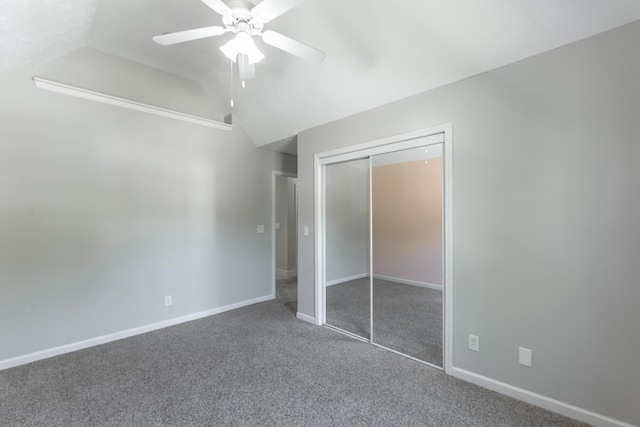 unfurnished bedroom featuring carpet floors, a closet, vaulted ceiling, ceiling fan, and baseboards