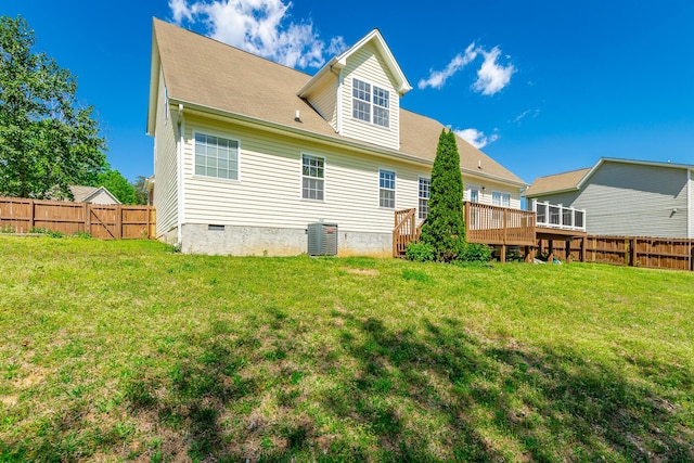 rear view of property with a yard, crawl space, a wooden deck, and a fenced backyard