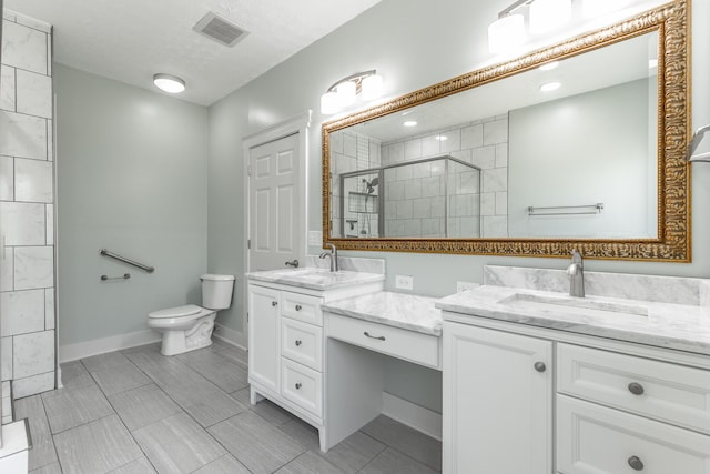 full bathroom featuring toilet, a stall shower, visible vents, and vanity