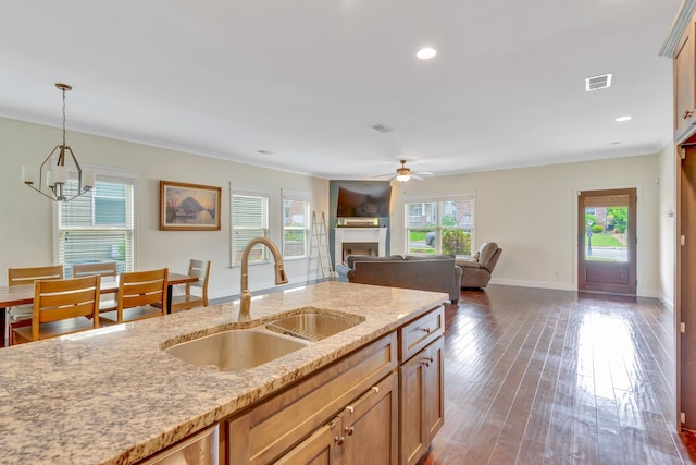 2835 Fernleaf Ln, Chattanooga, TN 37421 - kitchen featuring ceiling fan, a sink, a fireplace, decorative light fixtures, and visible vents