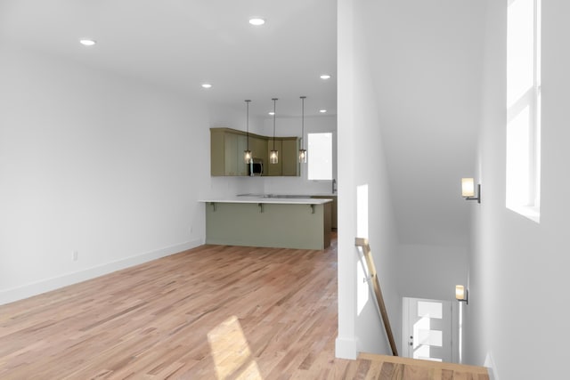 943 Montague Pl, Chattanooga, TN 37408 - unfurnished living room featuring baseboards, recessed lighting, and light wood finished floors