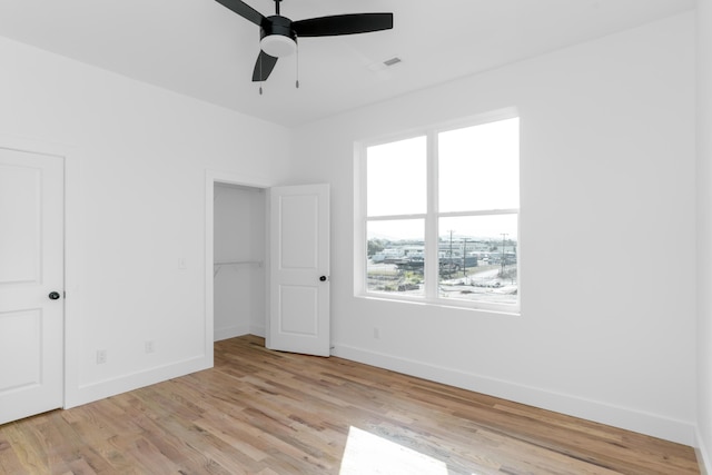943 Montague Pl, Chattanooga, TN 37408 - unfurnished bedroom with baseboards, ceiling fan, and light wood-style floors