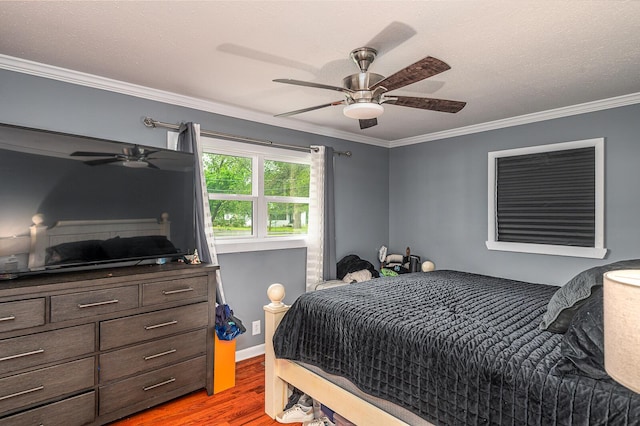 bedroom with crown molding, a ceiling fan, and light wood-type flooring