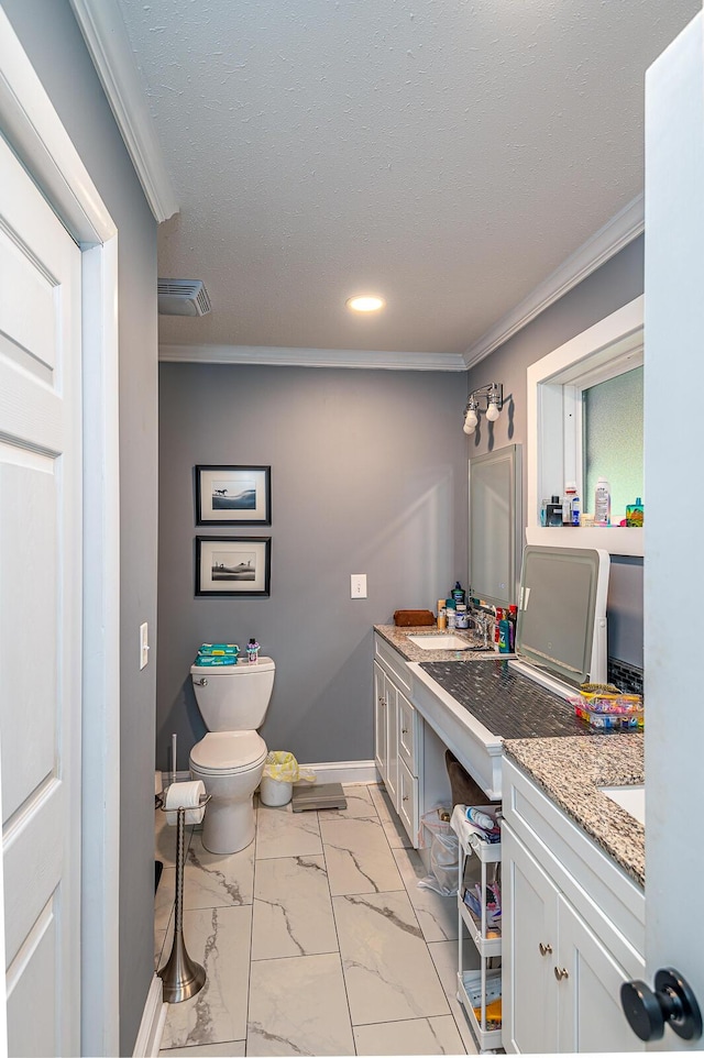 bathroom featuring vanity, toilet, ornamental molding, and marble finish floor