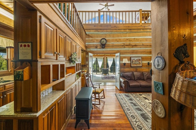 1011 Buffalo Rd, Jefferson City, TN 37760 - living area with a high ceiling, a ceiling fan, wood walls, and dark wood finished floors