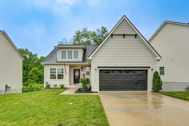 4130 Inlet Loop, Chattanooga, TN 37416 - view of front of house featuring a shingled roof, driveway, a front lawn, and a garage
