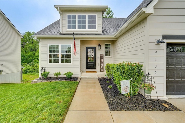 4130 Inlet Loop, Chattanooga, TN 37416 - view of exterior entry featuring roof with shingles, a lawn, and an attached garage