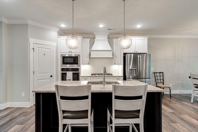 4130 Inlet Loop, Chattanooga, TN 37416 - kitchen featuring stainless steel appliances, premium range hood, baseboards, a center island with sink, and ornamental molding