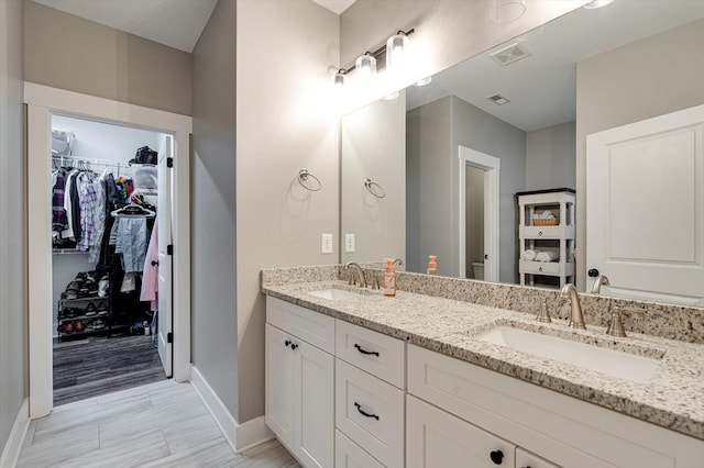 4130 Inlet Loop, Chattanooga, TN 37416 - bathroom featuring baseboards, a walk in closet, and double vanity