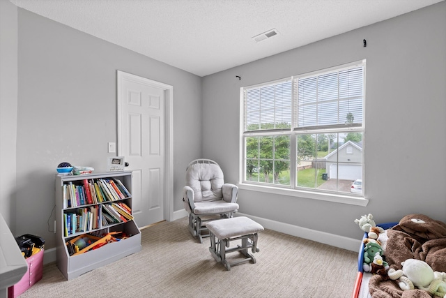 sitting room featuring baseboards, visible vents, and carpet