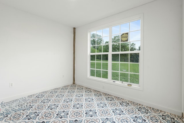 spare room with baseboards