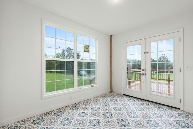 doorway to outside with a healthy amount of sunlight, french doors, and baseboards