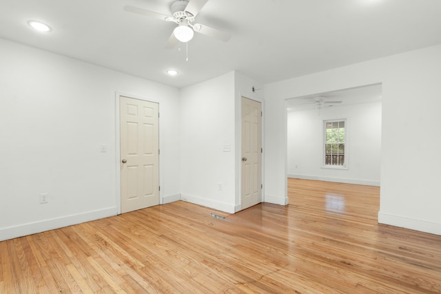 empty room with baseboards, recessed lighting, a ceiling fan, and light wood-style flooring