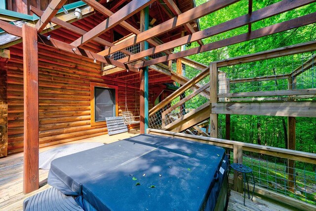 wooden deck with a covered hot tub