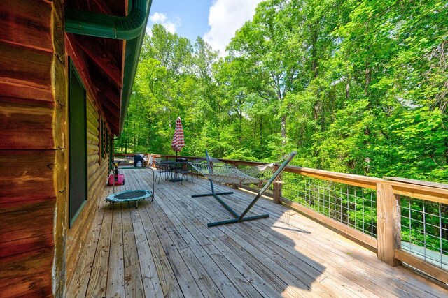 wooden deck featuring outdoor dining area