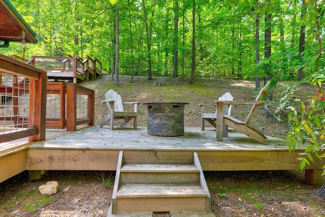 deck featuring a wooded view and stairway