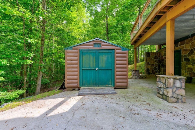 view of shed featuring a view of trees