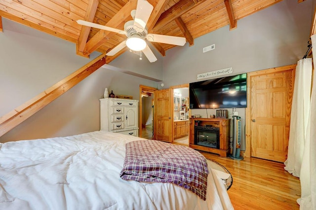 bedroom with visible vents, wooden ceiling, vaulted ceiling with beams, and wood finished floors
