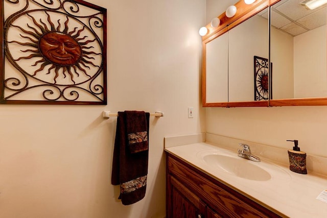 bathroom with vanity, visible vents, and a paneled ceiling
